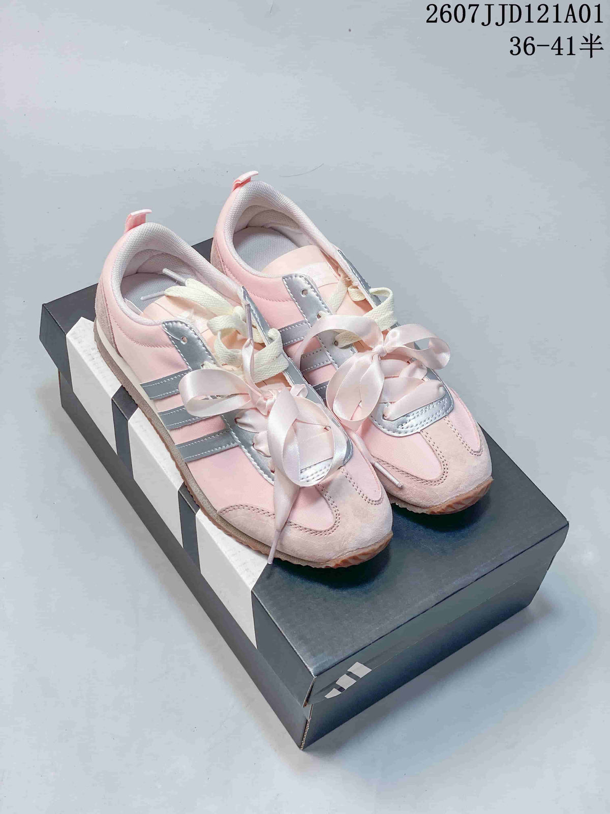 Pair of pink adidas VS JOG 2.0 sneakers with silver stripes and ribbon laces