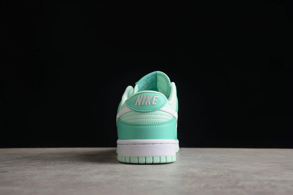 Rear view of one sneaker showing the Nike heel branding, layered heel panels, and mint green outsole.