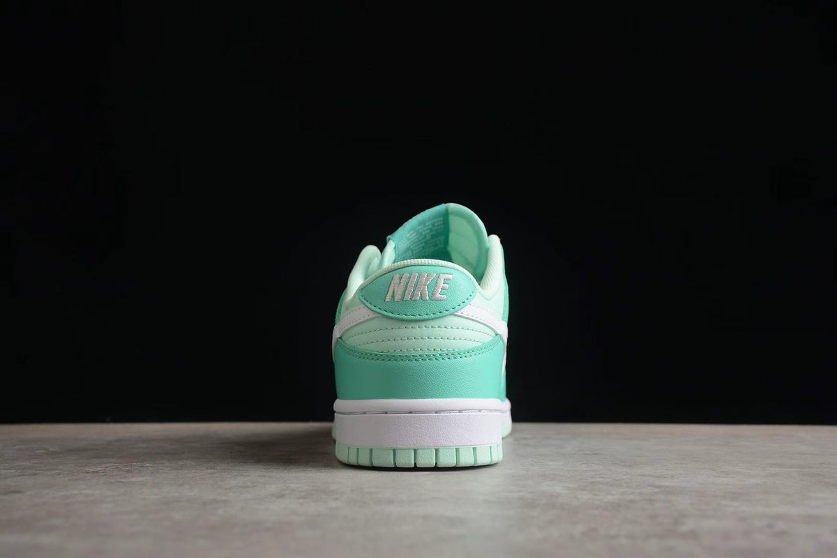 Rear view of one sneaker showing the Nike heel branding, layered heel panels, and mint green outsole.