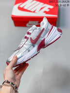 Side view highlighting the layered white and silver upper with red Nike detailing.