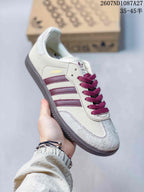 Cream adidas Samba sneaker with burgundy stripes and burgundy laces.