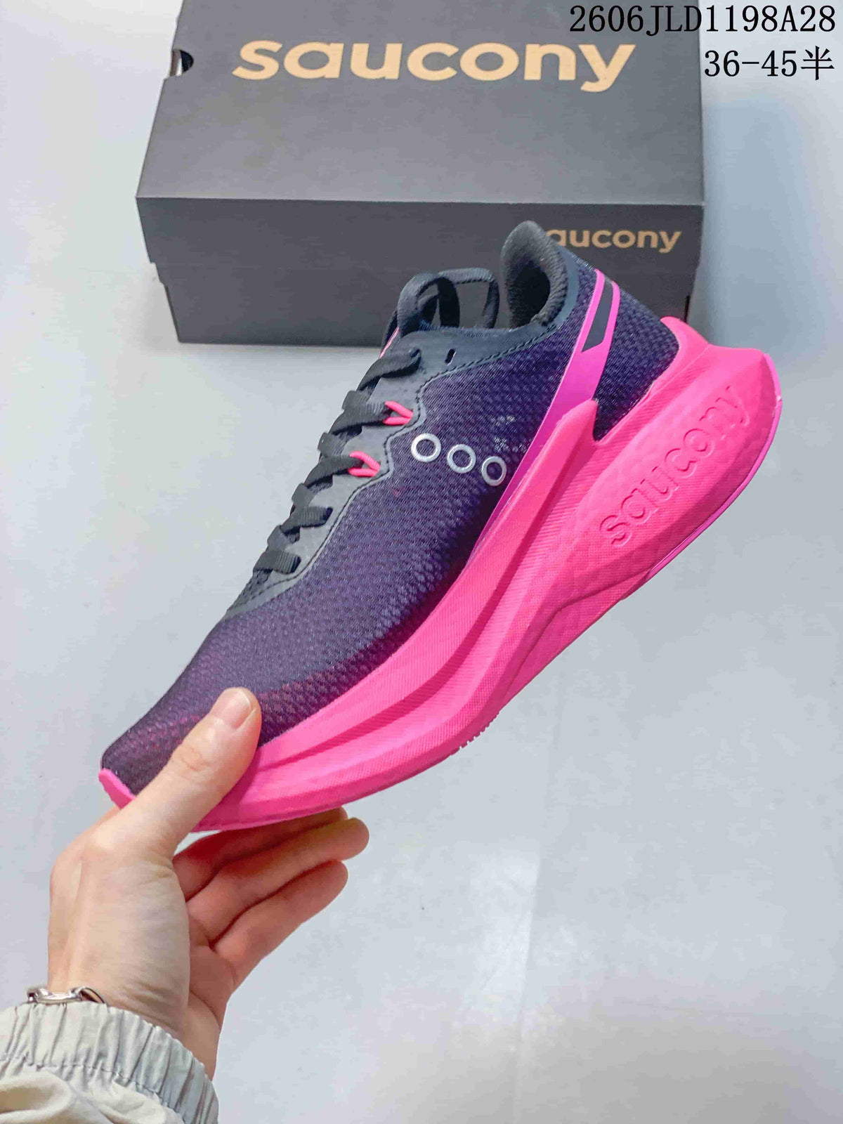 Side view of a navy and pink Saucony Endorphin Speed running shoe