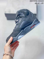 Side profile of the black high-top sneaker showing the perforated panel, red outsole accent and translucent outsole section.