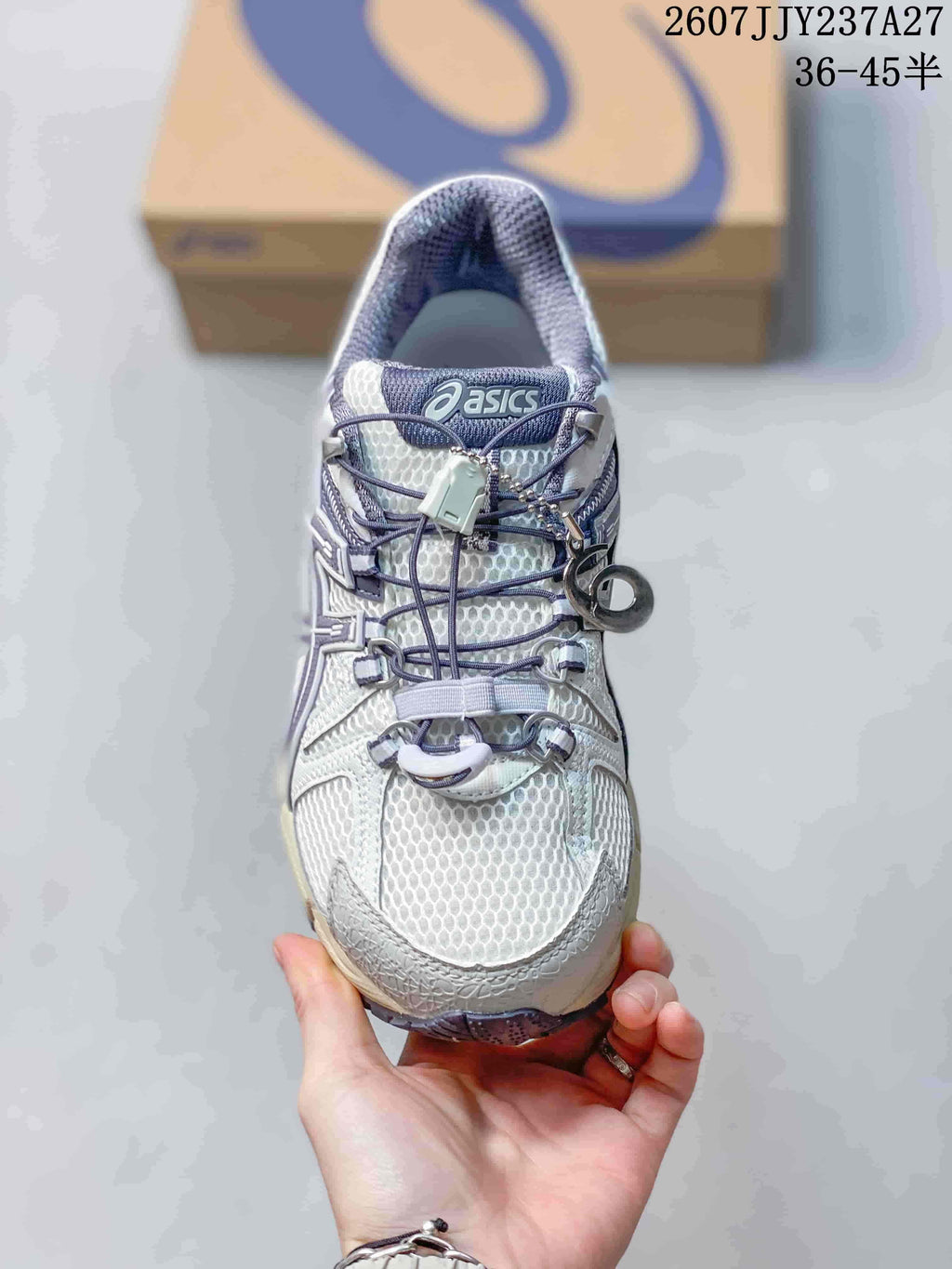 Top view showing the mesh-look toe box, cord lacing, lace-lock detail, and ASICS tongue branding.