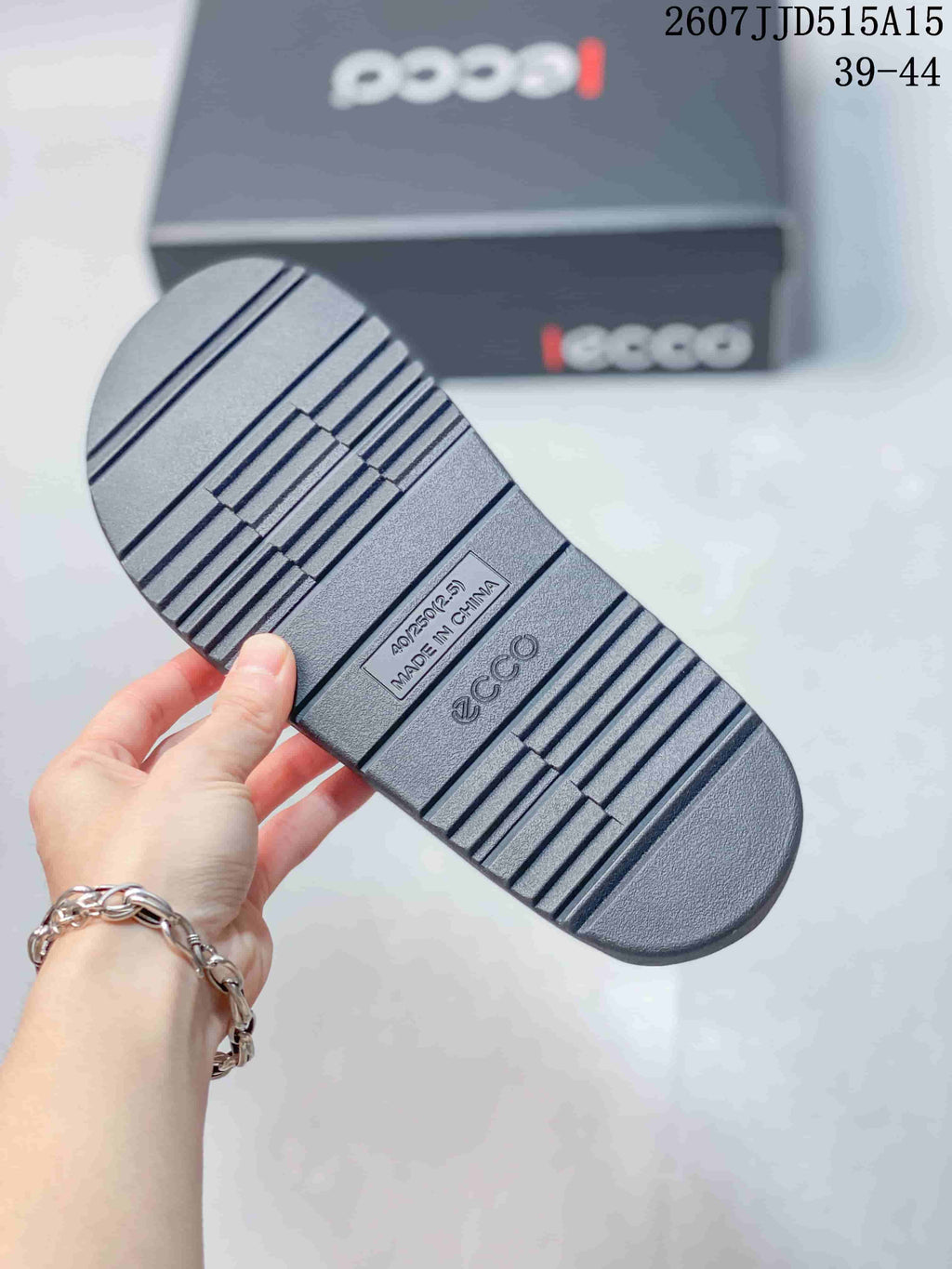 Close view of the sandal outsole showing a ridged tread pattern, ECCO branding, and Made in China text.