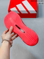 Underside of a pink running shoe showing a ridged outsole and size marking 39.0