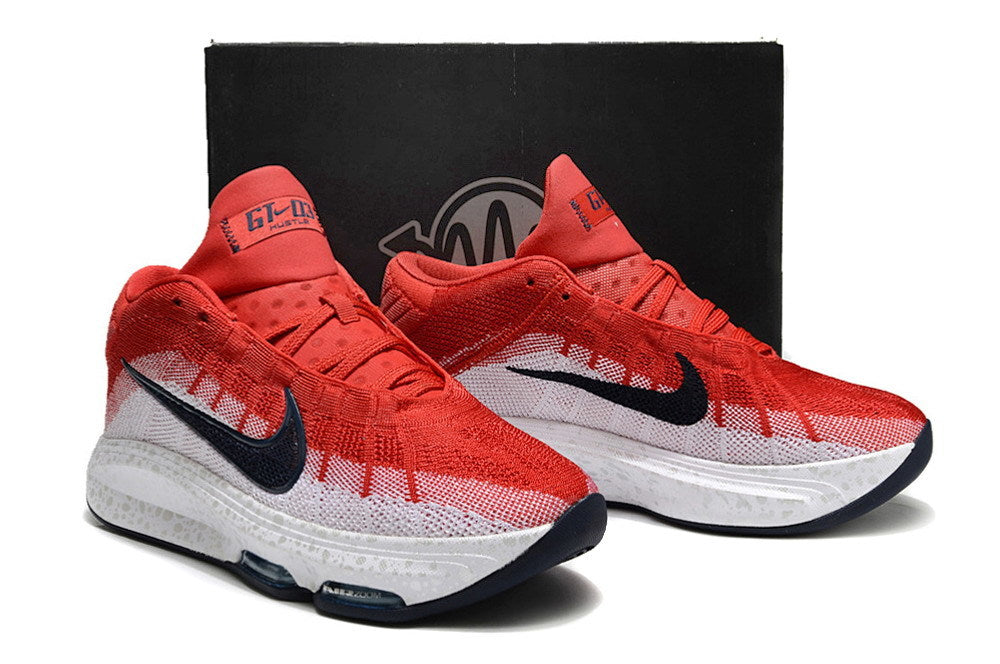Pair of red and white Nike GT Hustle 3 shoes displayed in front of a box.