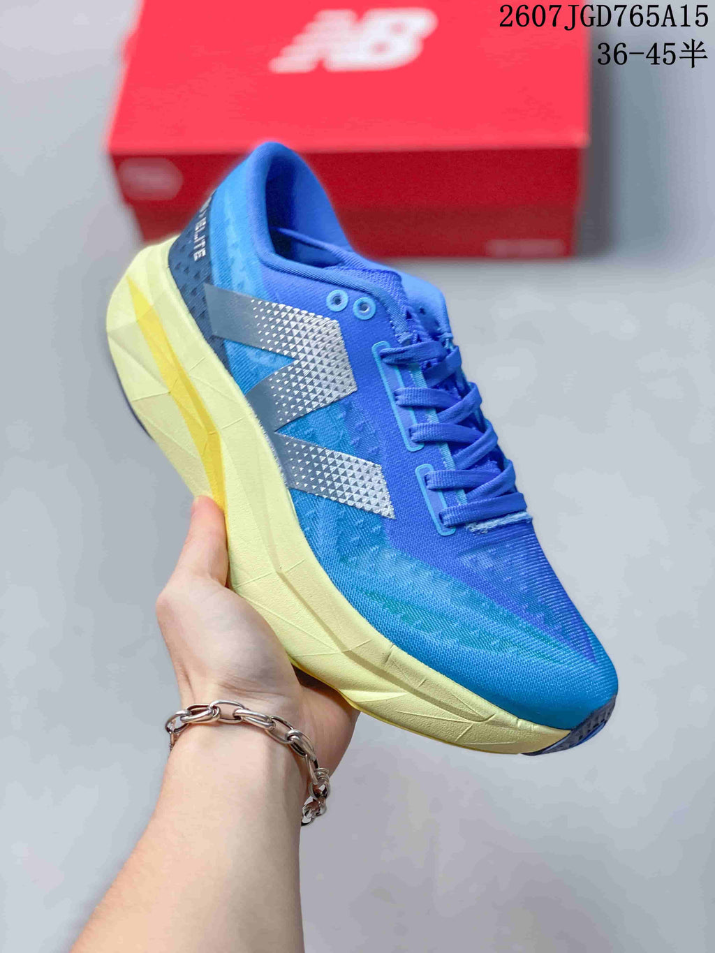Angled side view of the blue running shoe with silver-gray side branding, blue laces, pale yellow midsole, and dark outsole details.