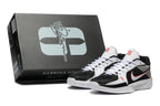 Black, white, and red Nike Sabrina basketball shoes beside a branded box