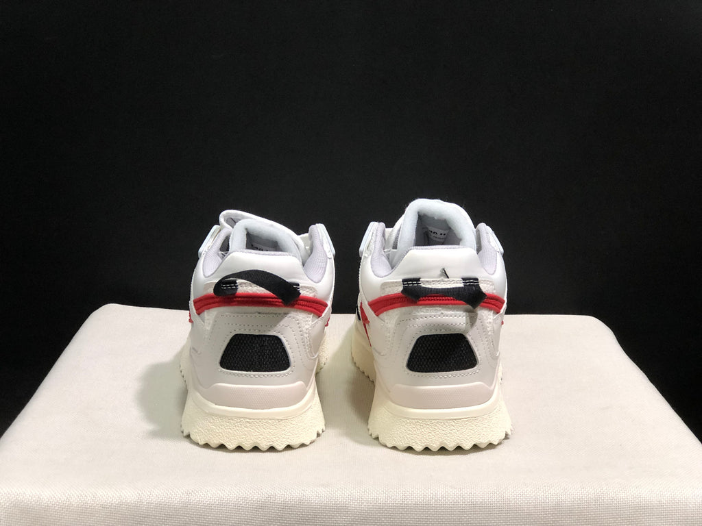 Rear view showing black mesh heel panels, red trim, and black-and-red pull tabs.