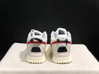 Rear view showing black mesh heel panels, red trim, and black-and-red pull tabs.