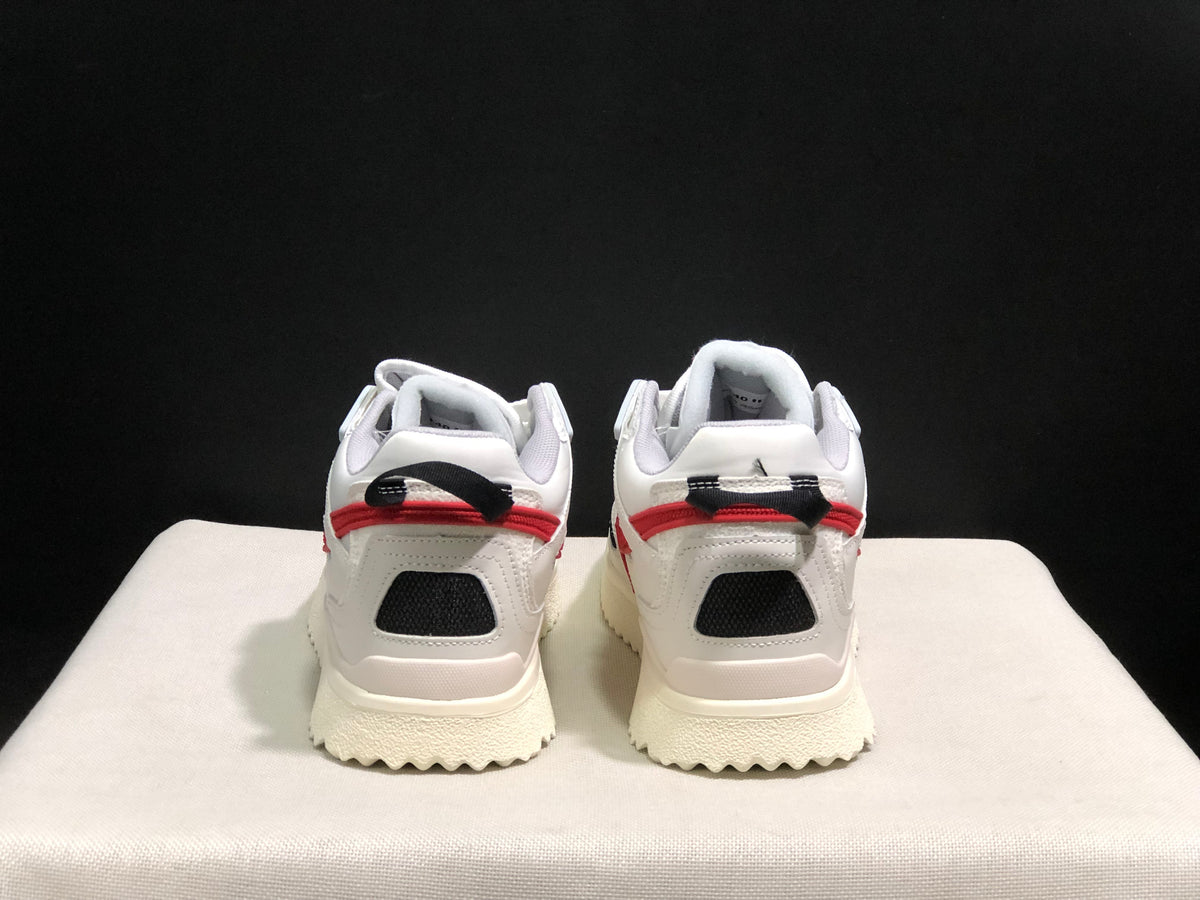 Rear view showing black mesh heel panels, red trim, and black-and-red pull tabs.