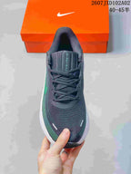 Top view of a charcoal Nike running shoe with green detailing and lace-up closure; tongue reads Journey Run 2, and image text shows 40–45.