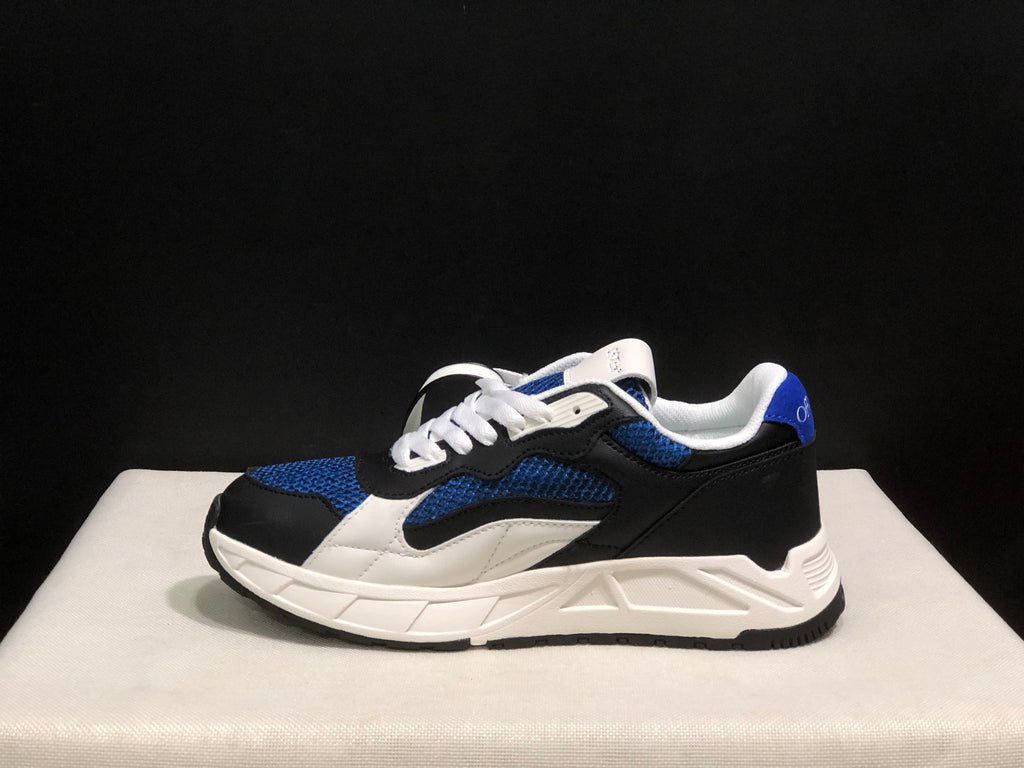 Side view of one sneaker showing the black heel, blue upper panels, white detailing, and sculpted white midsole.