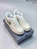 Pair of white Nike Air Force 1 ’07 low-top sneakers with sage-green accents