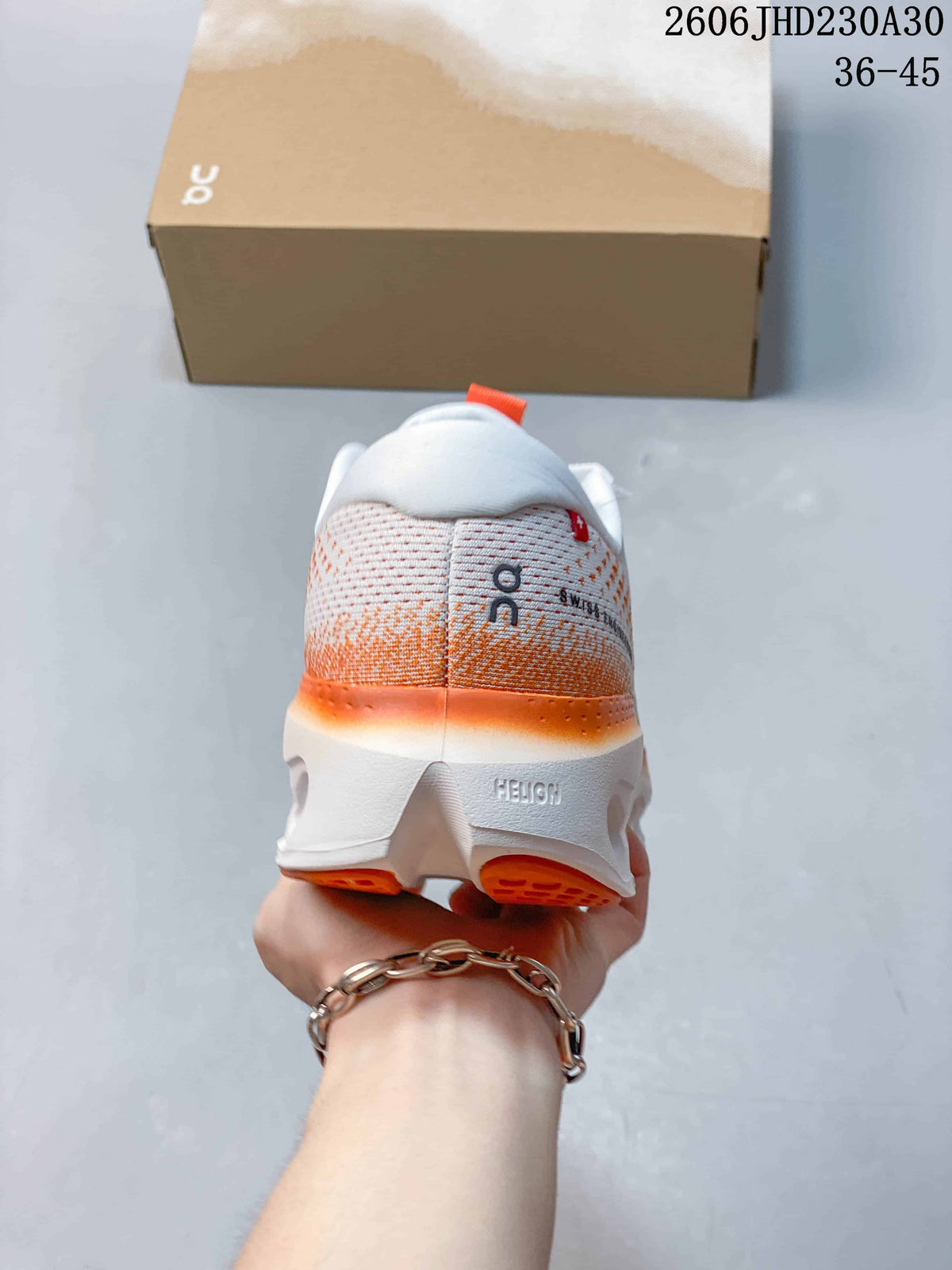 Rear view of a white and orange sneaker with a sculpted heel sole