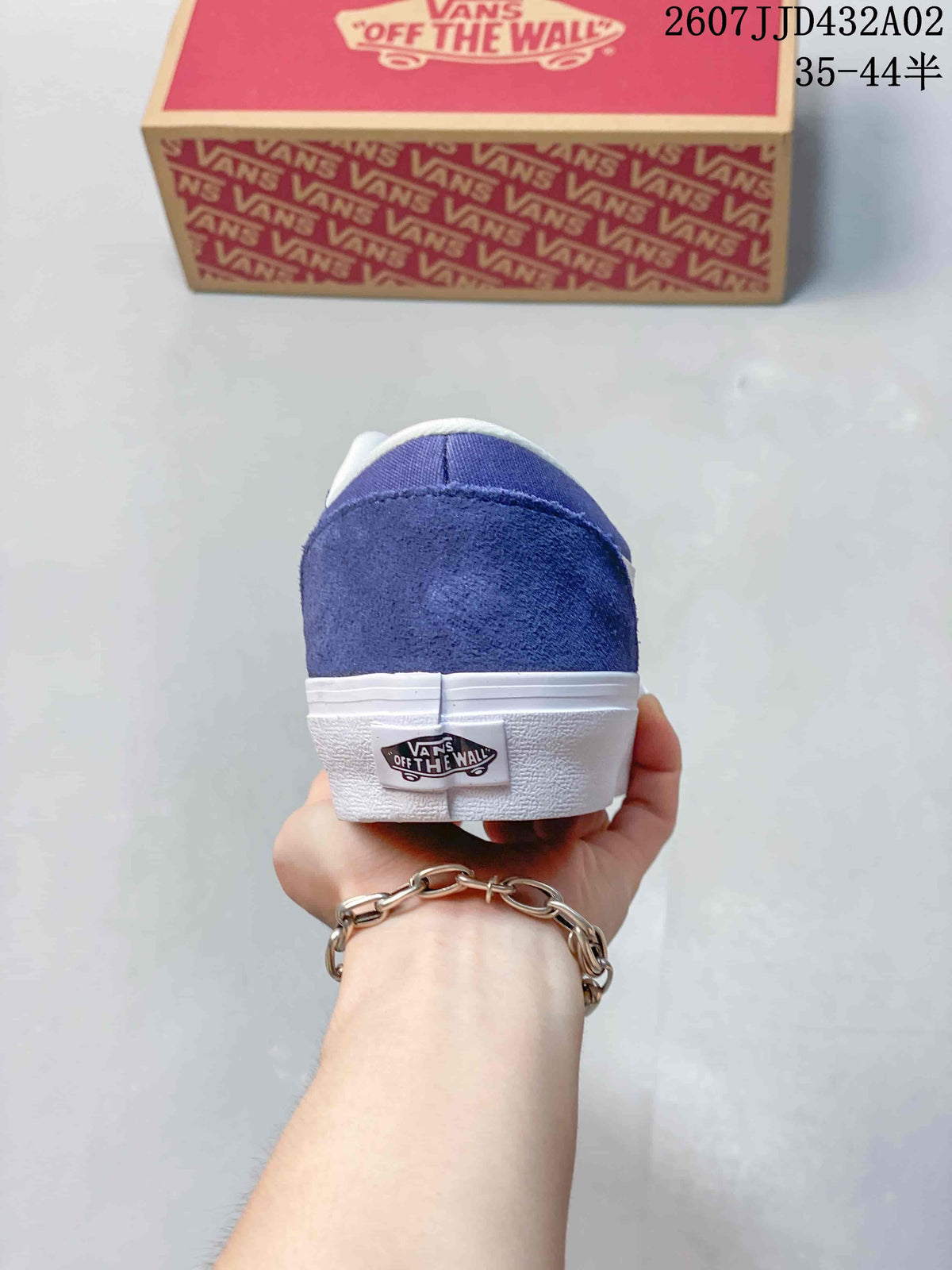 Rear view of the blue sneaker with a white sole and heel label