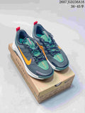 Pair of dark gray Nike ReactX Wildhorse 10 trail sneakers with orange and green accents displayed on a branded shoe box.