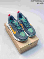 Pair of dark gray Nike ReactX Wildhorse 10 trail sneakers with orange and green accents displayed on a branded shoe box.