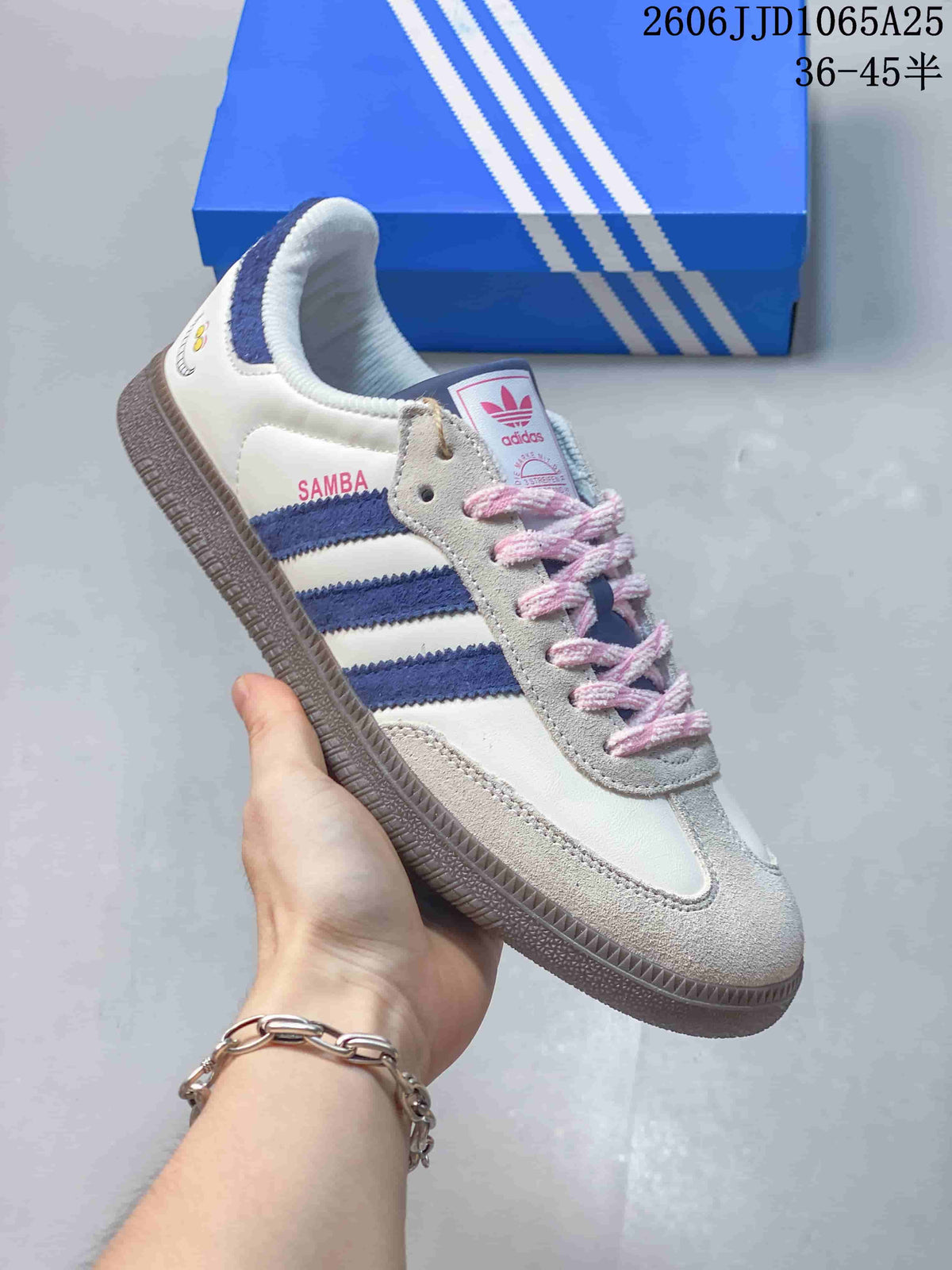 Side view of a white sneaker with blue stripes, pink laces and a dark outsole