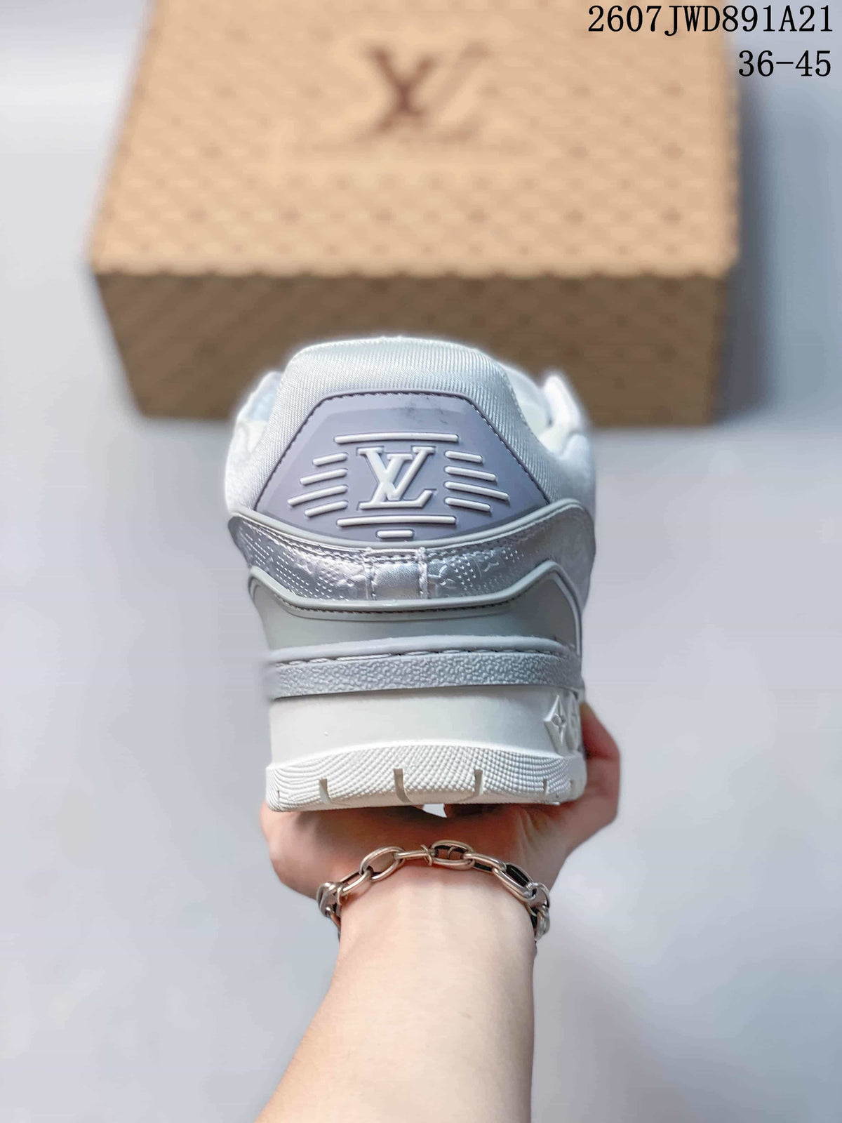 Rear view of the silver and white sneaker showing the padded heel and raised outsole.