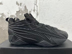 Side view showing the black sneakers’ sculpted ribbed panels