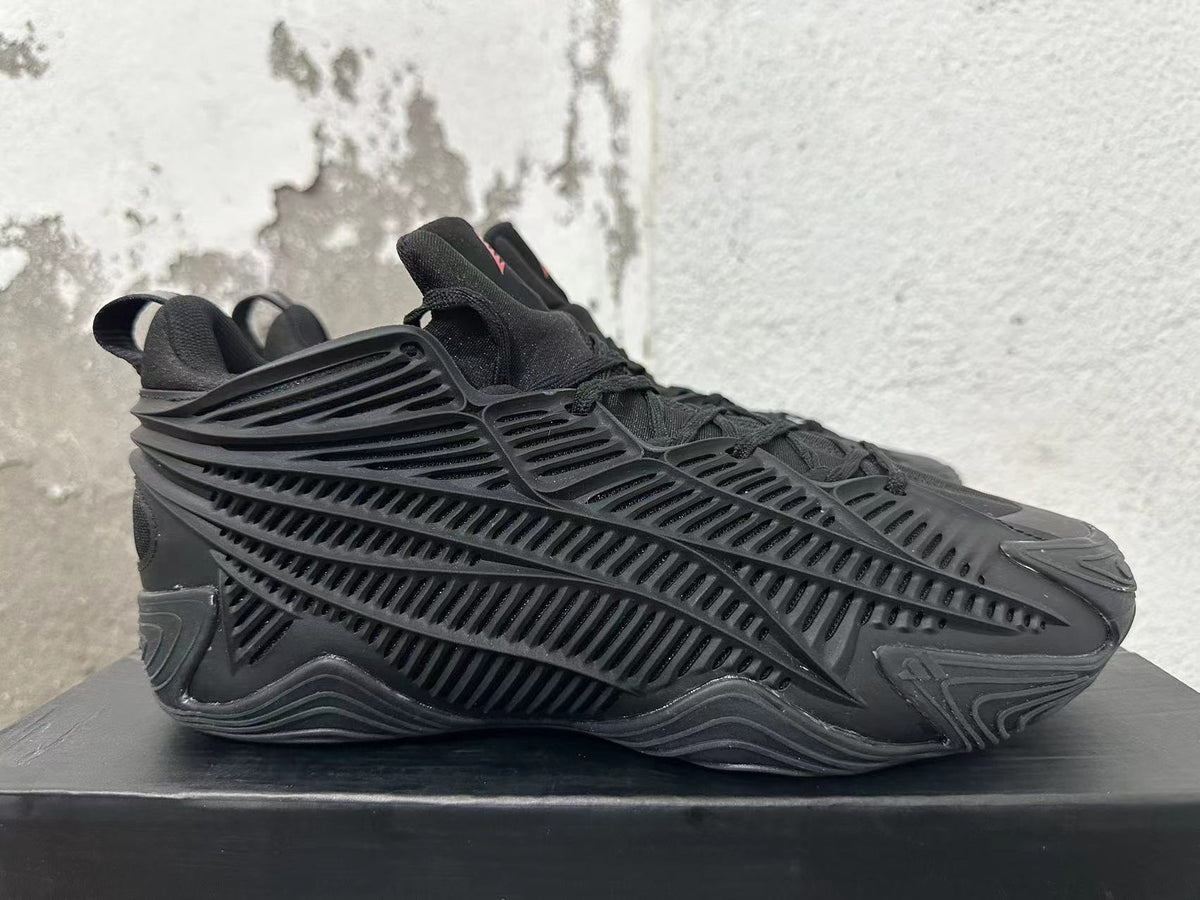 Side view showing the black sneakers’ sculpted ribbed panels