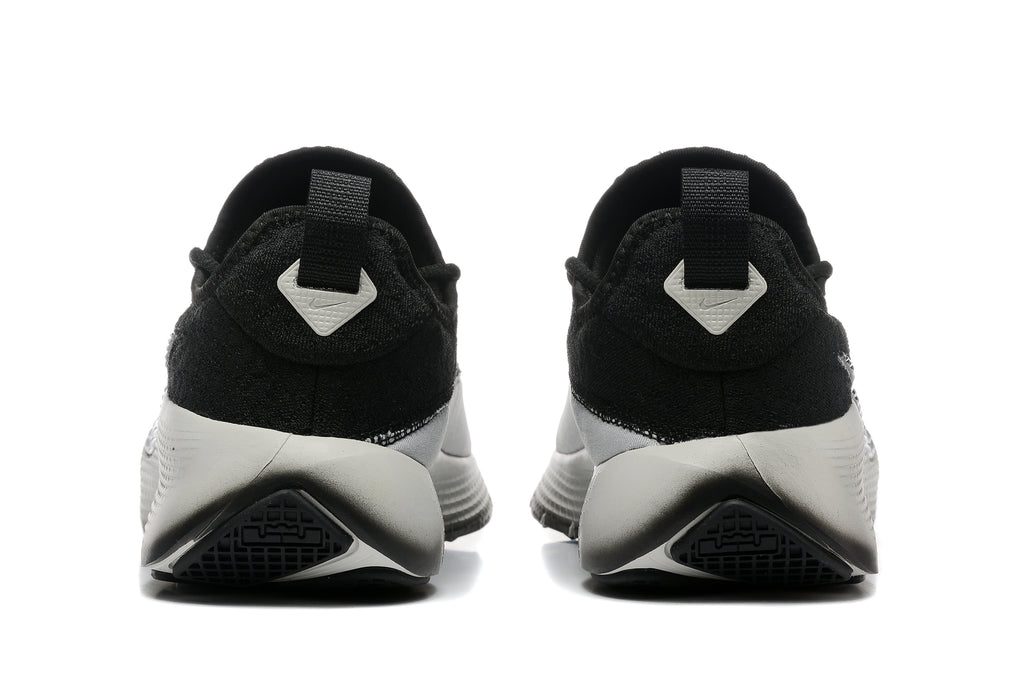 Rear view of the black and white training shoes showing heel pull tabs and outsole details.