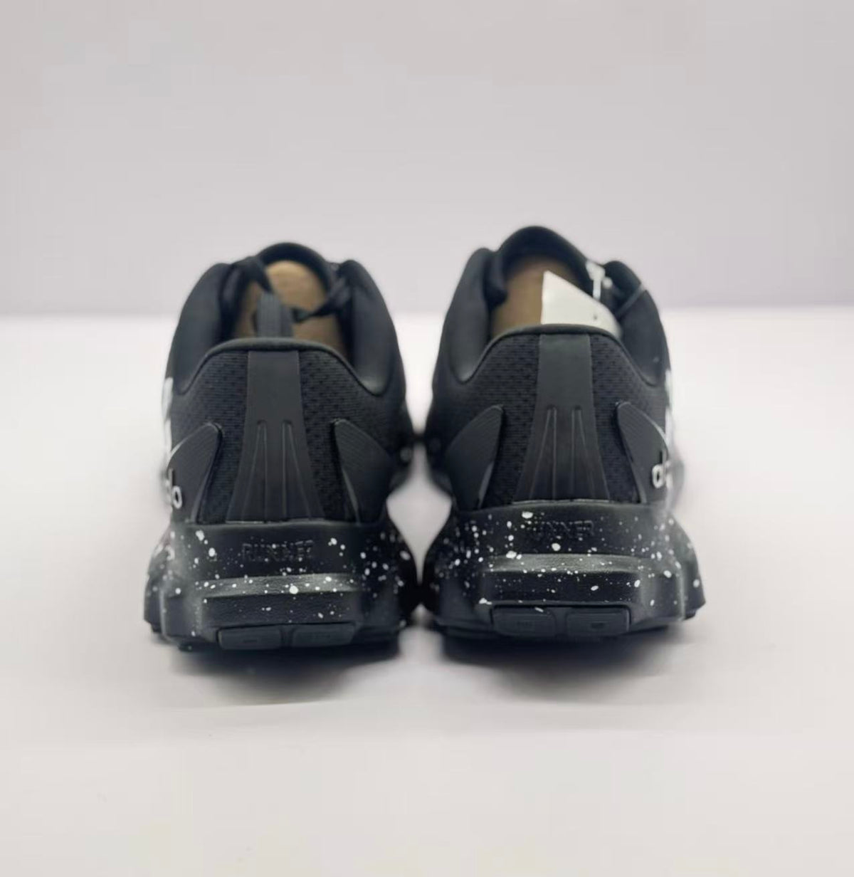 Rear view of the pair showing padded collars, heel panels and treaded soles.