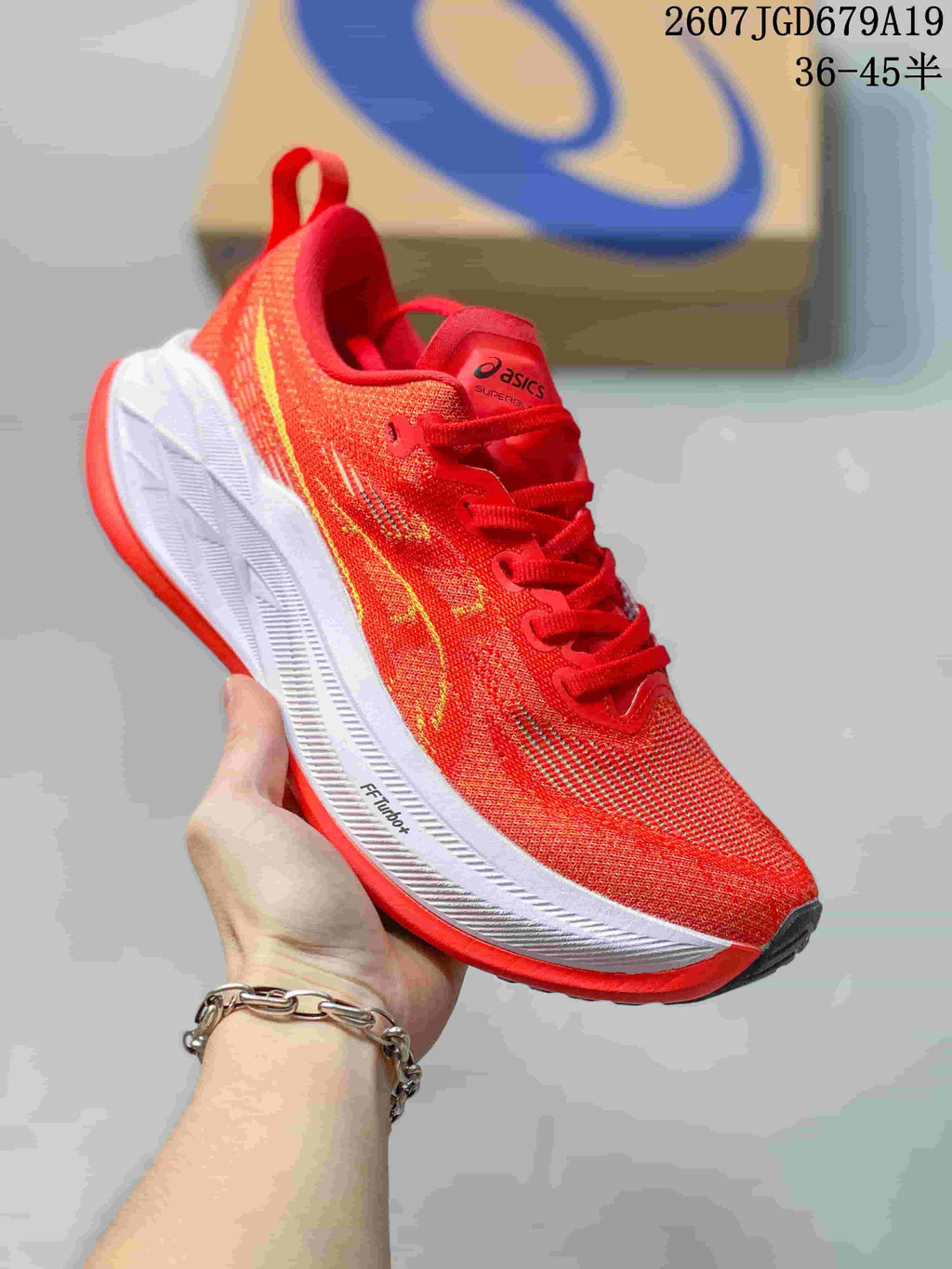 Red ASICS SUPERBLAST 2 running shoe with yellow side detailing and a white midsole, shown from a front three-quarter angle.