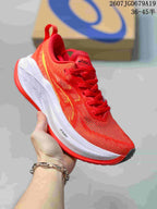 Red ASICS SUPERBLAST 2 running shoe with yellow side detailing and a white midsole, shown from a front three-quarter angle.