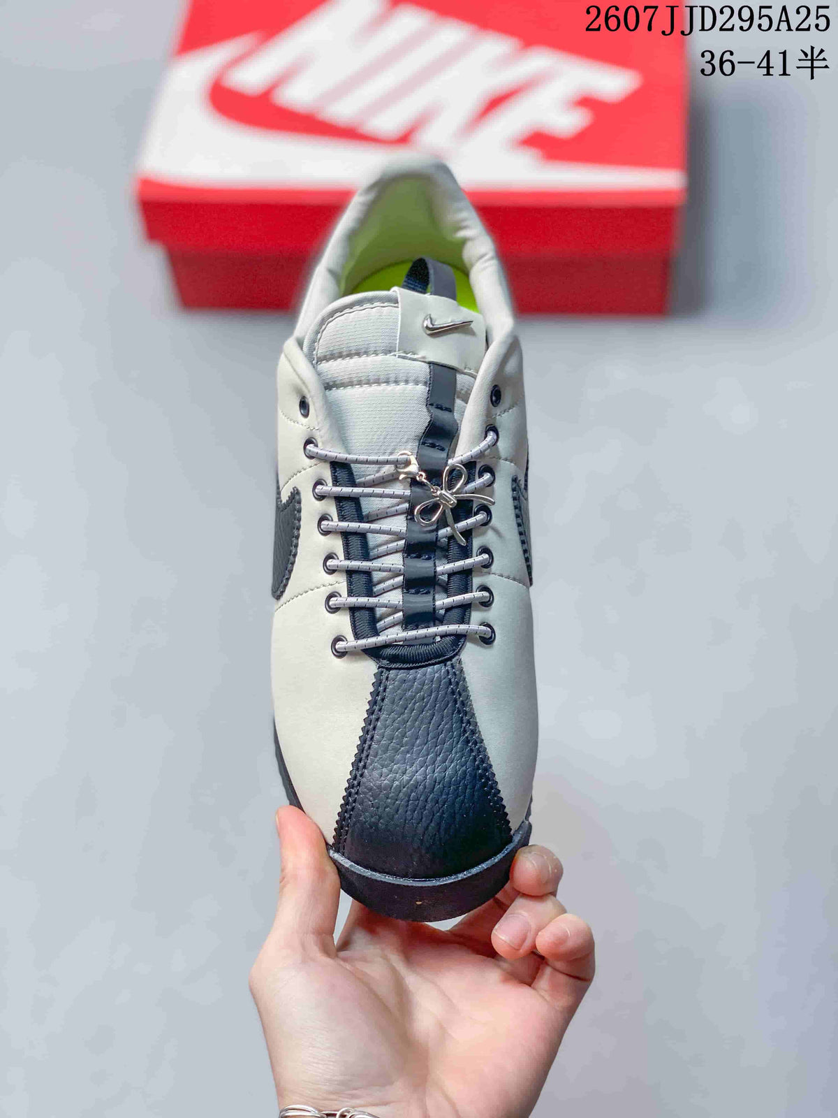Top view showing the laces, metal-tone eyelets, tongue, and dark textured toe cap.