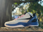 Side view of a white Nike Kobe 6 with a black Swoosh, pink laces, and blue heel and midsole.