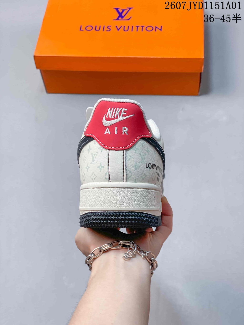Rear view showing a red heel tab, patterned cream panels, and an orange box.