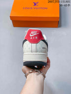 Rear view showing a red heel tab, patterned cream panels, and an orange box.