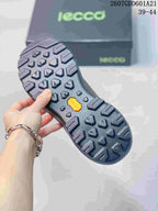 Underside of a brown ECCO shoe showing the black lugged outsole and textured tread pattern.