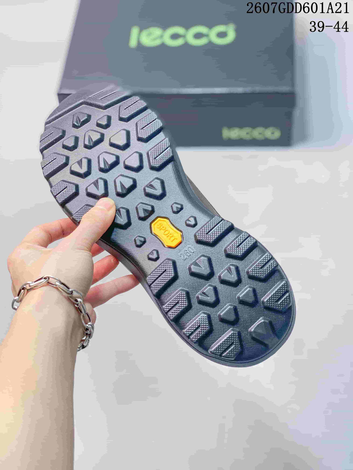 Underside of a brown ECCO shoe showing the black lugged outsole and textured tread pattern.