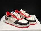 Three-quarter view of the pair highlighting the white star side details, black overlays, cream laces, and red accents.