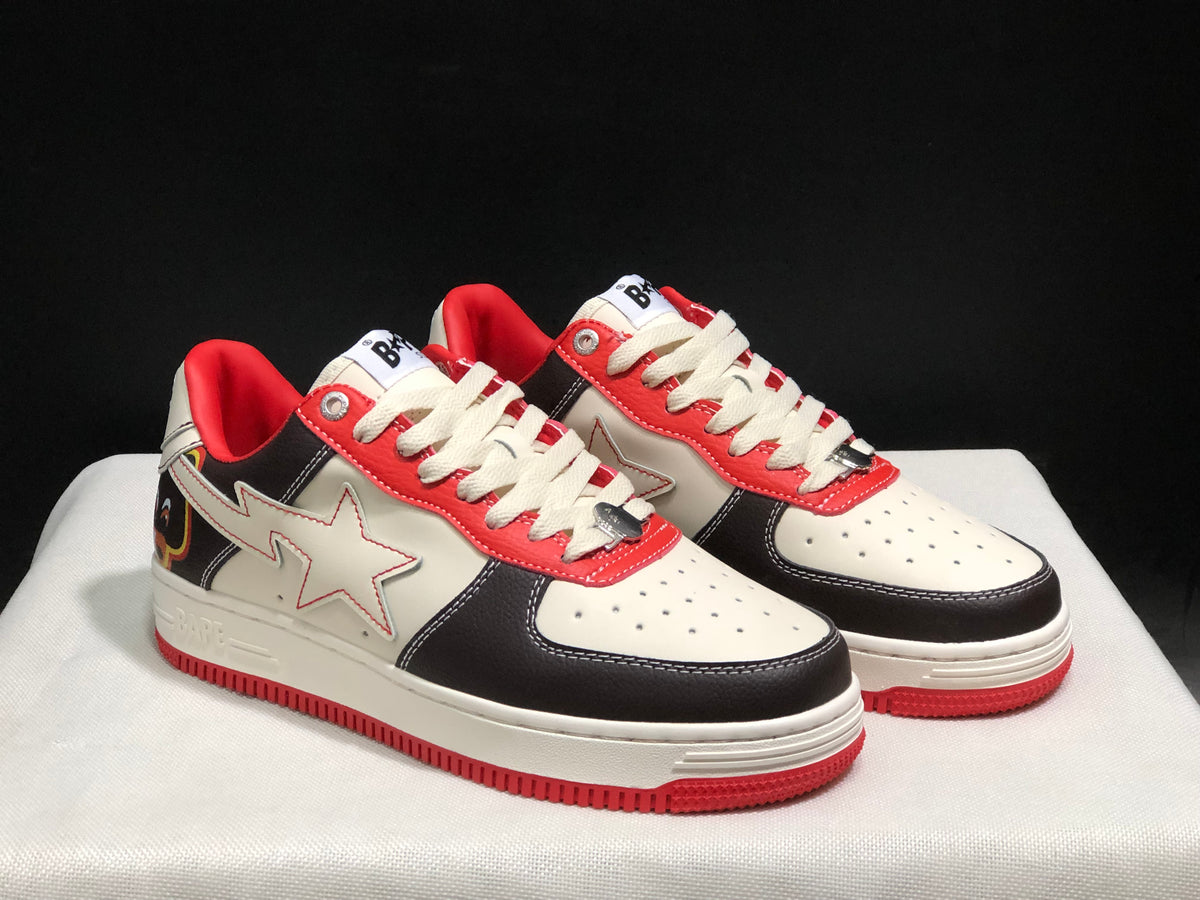 Three-quarter view of the pair highlighting the white star side details, black overlays, cream laces, and red accents.