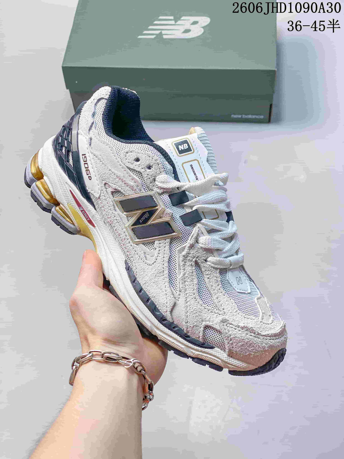 White and pale gray New Balance M1906R sneaker with dark accents