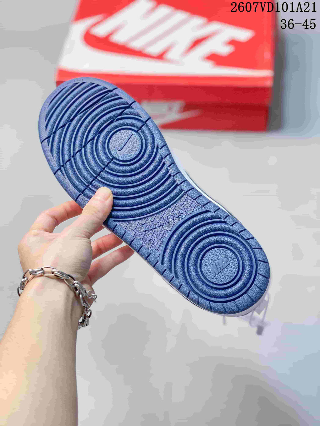 Close-up of the blue rubber outsole showing concentric traction circles and molded branding.