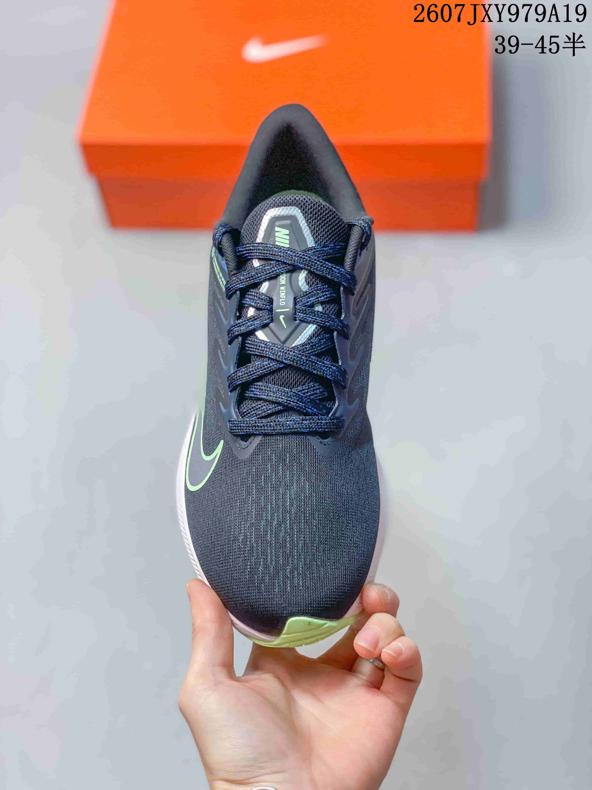 Top view of the dark navy lace-up sneaker with green side detailing and a light green toe accent; overlay shows style code 2607JXY979A19 and size range 39–45.