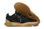 Black Nike basketball shoe with gold accents and gum-colored outsole.