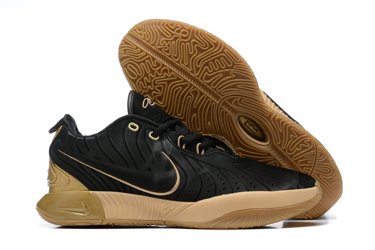 Black Nike basketball shoe with gold accents and gum-colored outsole.