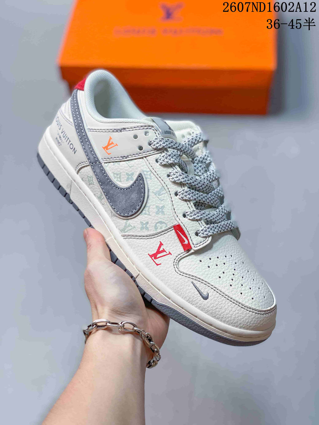 Angled side view showing the white and gray upper, red accent details, patterned side panel, gray Swoosh, and low-top construction.
