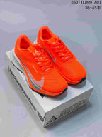Pair of bright orange Nike ACG trail shoes with light-colored accents