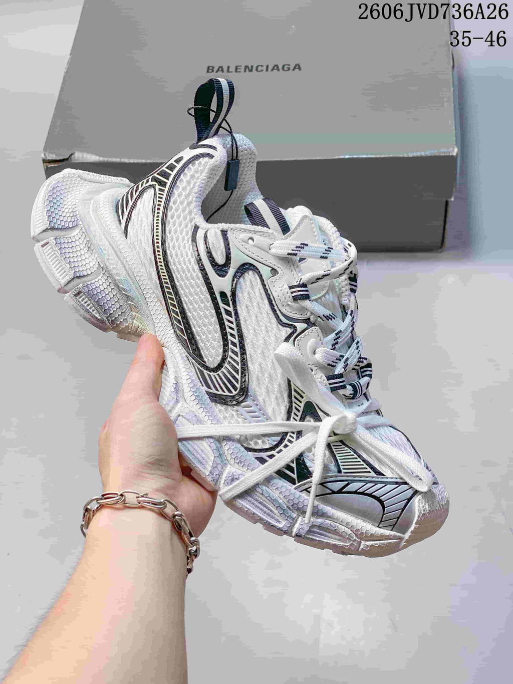 White Balenciaga 3XL-style sneaker with black and silver accents
