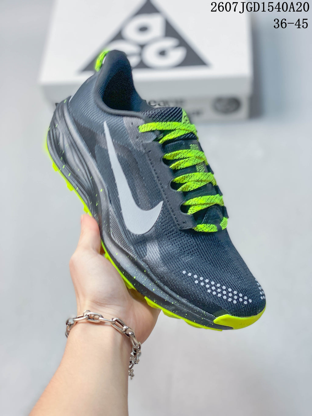 Angled side view showing the dark gray upper, swoosh, neon green laces, and outsole edge.