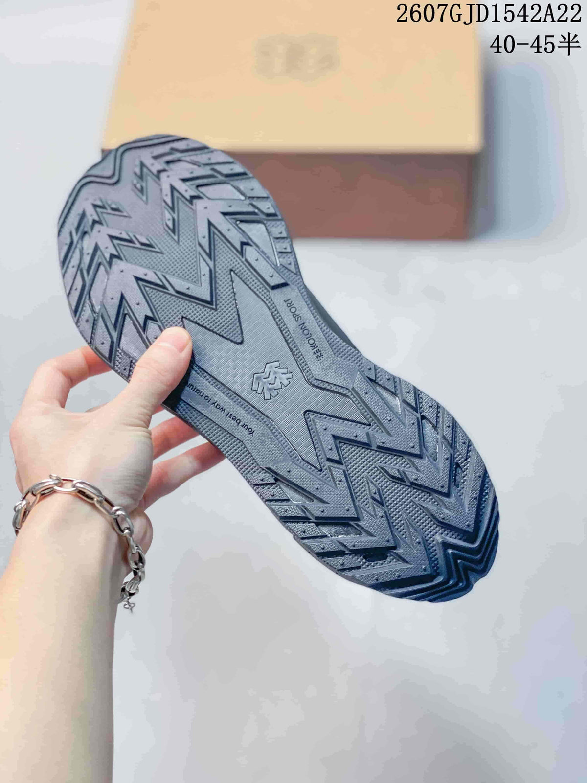 Close-up of the textured outsole with a bold angular lug pattern and KOLON SPORT branding.