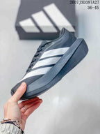 Side profile of the black and white sneaker showing layered side stripes and a thick dark sole.